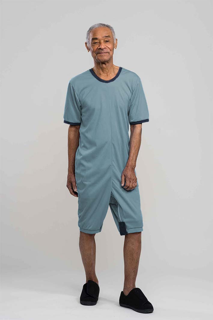 Adaptive short legs onesie designed for people suffering from dementia. A zipper on the back of the garment prevents the wearer from undressing.  A large, zippered crotch opening facilitates diaper changes.  Durable soft mesh knit dries quickly. Can be wo
