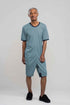 Adaptive short legs onesie designed for people suffering from dementia. A zipper on the back of the garment prevents the wearer from undressing.  A large, zippered crotch opening facilitates diaper changes.  Durable soft mesh knit dries quickly. Can be wo