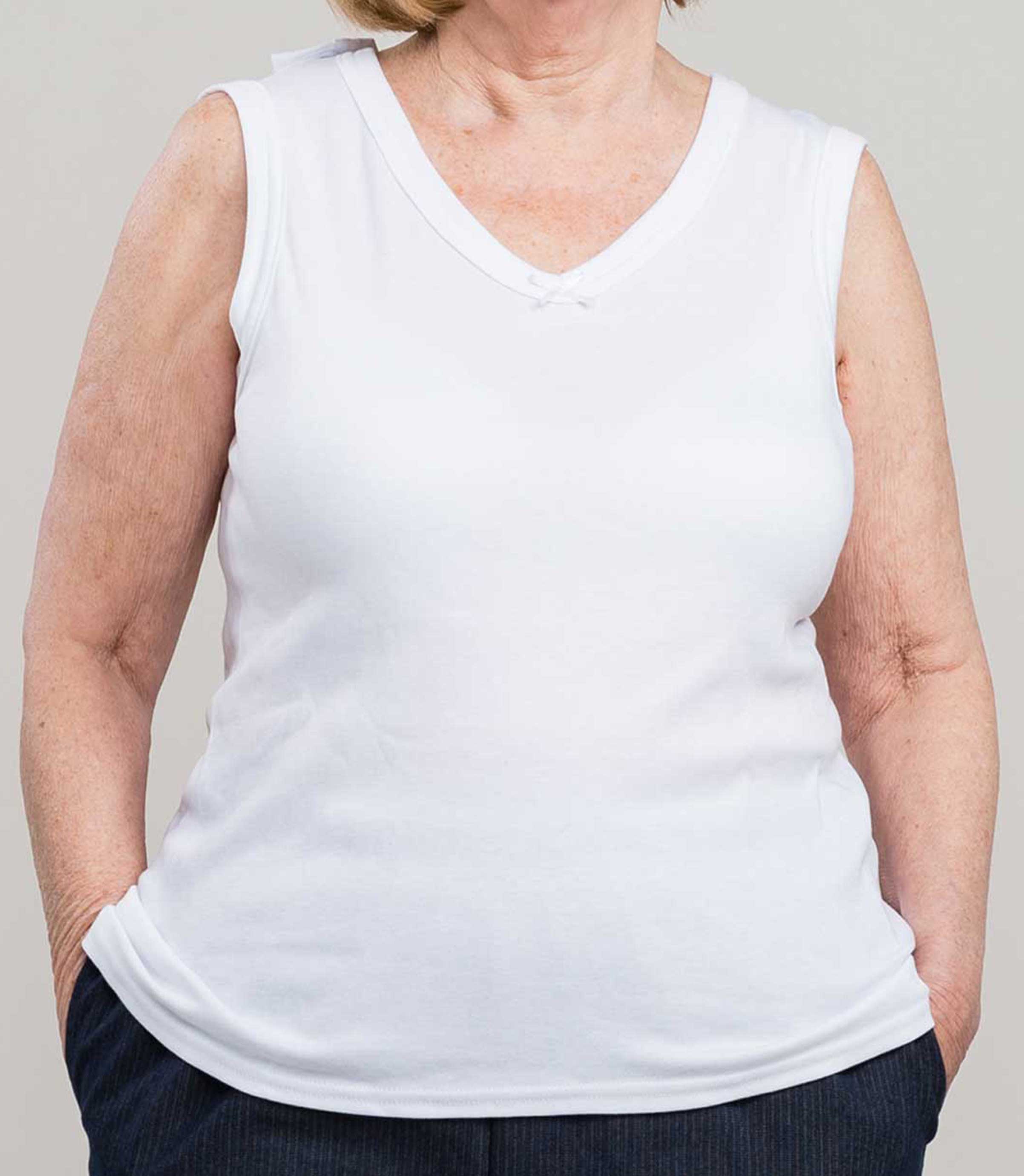 Upgrade your layering game with our Adaptive Undervest. The adaptive camisole, adorned with an elegant V-neckline and charming bow, adds a touch of femininity to any outfit. Made of soft white knit, it provides ultimate comfort and style.