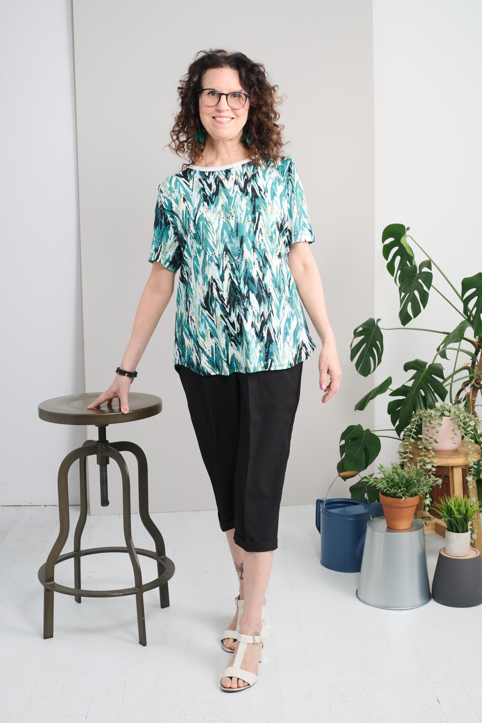 This adaptive basic top is designed with short sleeves and a stretch knit fabric for comfort and ease of movement. The round collar and glitter embellishments add a touch of style to any outfit. Designed to support those with limited mobility, this top ma