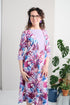 This adaptive dress features 3/4 sleeves, a leaf pattern and pastel color for a fashionable look. The open back and metal snaps make it easy to put on and take off, providing comfort and convenience for individuals with limited mobility.