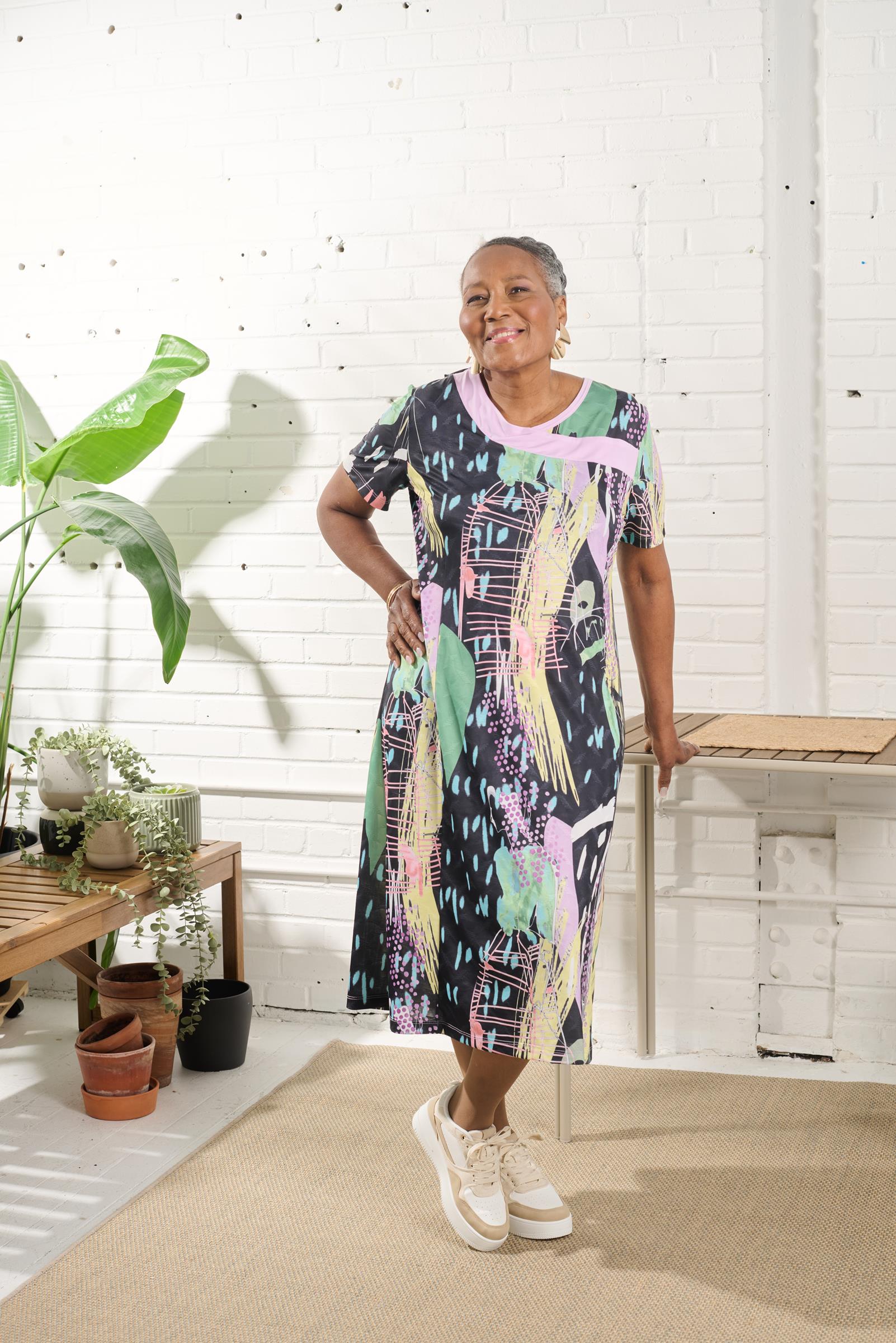 This adaptive dress is the perfect combination of comfort and style. With its stretch knit material and large opening, it provides ease of dressing for individuals with limited mobility. The metal shoulder snaps make it easy to put on and take off. Its sh